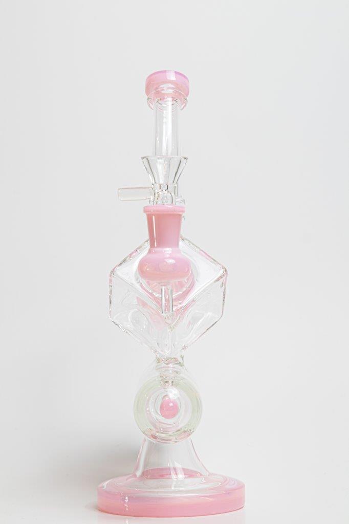 Pink Incline Water Pipe – an 10-inch cube-designed wonder perfect for weed and dabs. Now available for sale, this distinctive piece includes a 14MM male bowl for weed, a bent-down stem, and a bubble percolator, providing a unique smoking experience with efficient filtration. The percolator prevents water from splashing back into your mouth, cools the smoke down