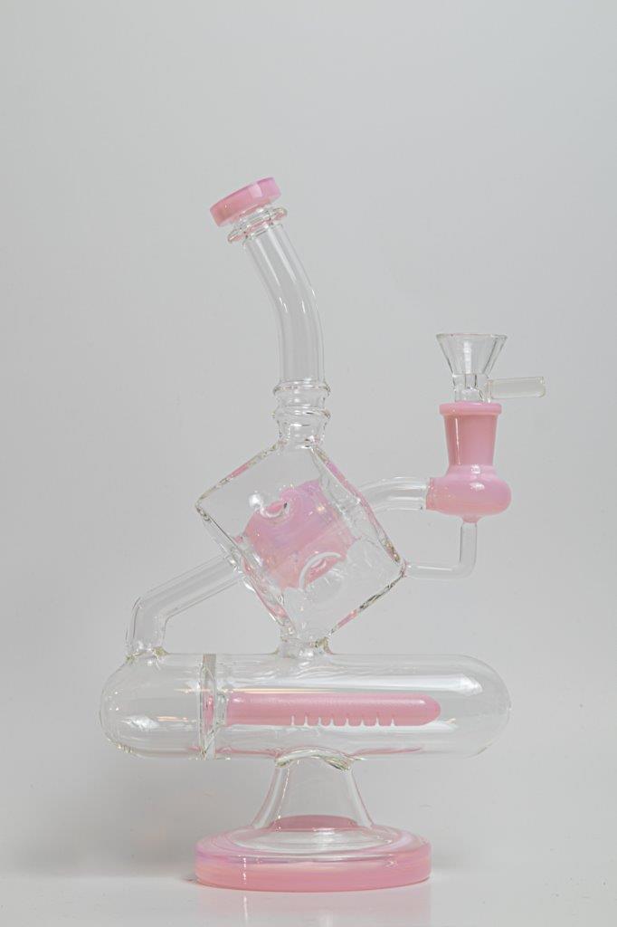 Pink Incline Water Pipe – an 10-inch cube-designed wonder perfect for weed and dabs. Now available for sale, this distinctive piece includes a 14MM male bowl for weed, a bent-down stem, and a bubble percolator, providing a unique smoking experience with efficient filtration. The percolator prevents water from splashing back into your mouth, cools the smoke down
