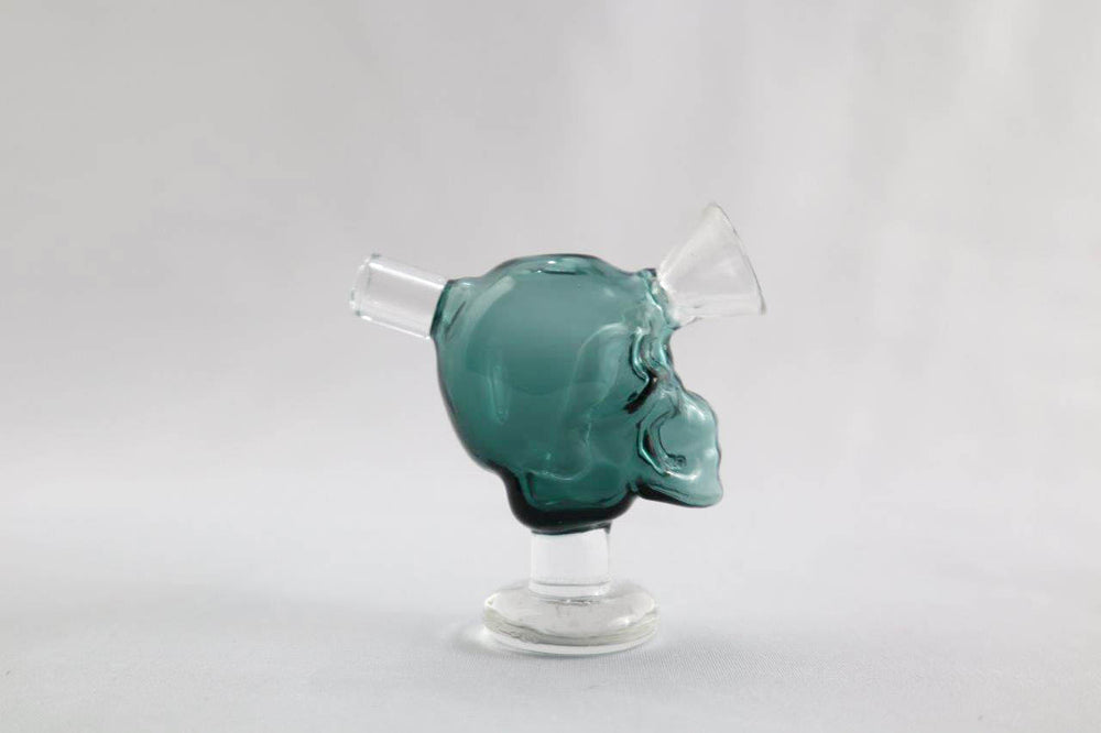 Teal/blue skull shape 2.75-inch Skull Blunt/Joint Bubbler – the ultimate stoner's choice for sale at an affordable price. Shaped like a pipe with a skull design, this piece is exclusively for only dry herb use. Grab yours and add a bold edge to your smoke routine. Quality glass