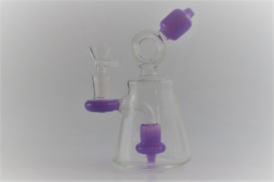 6.25-inch Purple Donut Recycler – the ultimate companion for weed and dabs in water bong style glass. Now for sale, this dope recycler features a 14MM male bowl piece for weed and a bent down stem. Color purple 